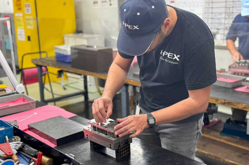 I-PEX technician fine-tuning precision mold