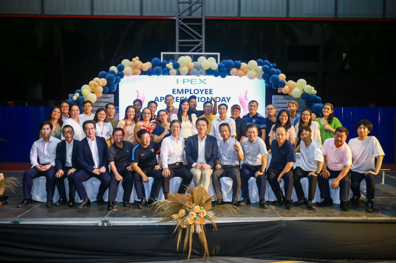 Group of employees posing together during an outdoor team activity