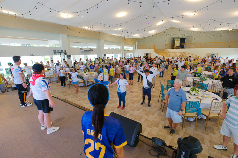Employees gathered in a large hall for a company-wide event