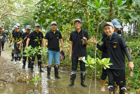I-PEX Thailand employees participating in an environmental conservation activity near water