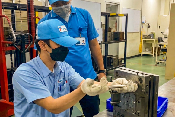 I-PEX Thailand workers checking mold components