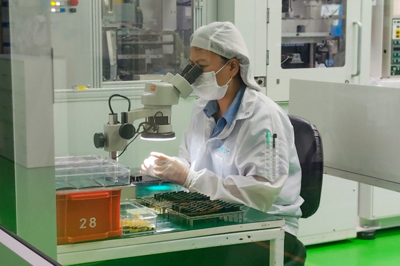 Worker assembling products in a cleanroom